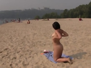 Beautiful teen plays at the beach nude