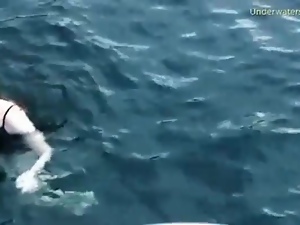 Group of girls swims naked in the ocean