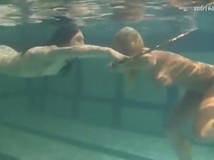 Underwater girls play with a hula hoop