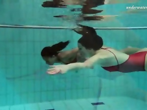 Two beauties get naked underwater