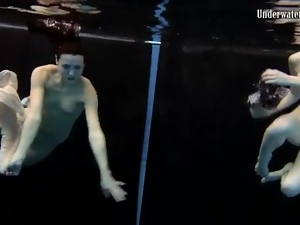 Skinny teens swim in the deep pool naked