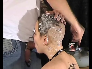 Shaving her head as she sucks his dick