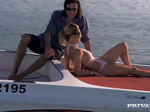 Smoking hot blondie is taking two huge cocks on the boat