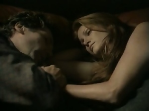 Angie Everhart rolling around on a bed with a guy before