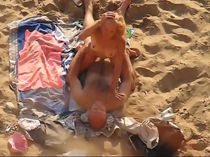 Guy makes love to his cute GF on a beach in front of a hidden cam