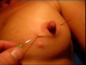 Long needle through her milf nipple