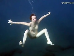 Redheaded girl is so sexy naked in the water