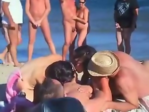 four friends have sex on nude beach in front of crowd